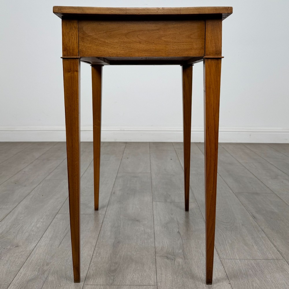 An antique early 20th-century walnut side table with a flat rectangular top, plain frieze, and four square tapered legs. View III