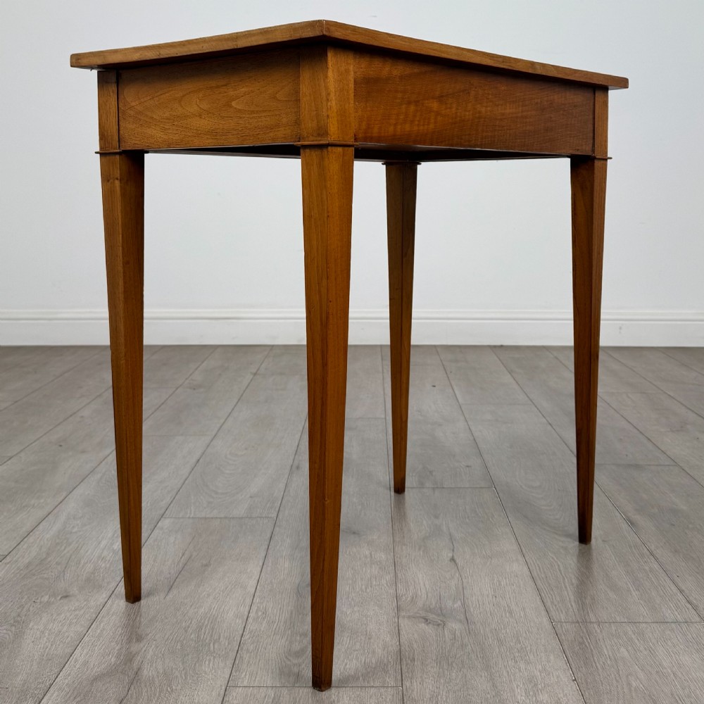 An antique early 20th-century walnut side table with a flat rectangular top, plain frieze, and four square tapered legs. View IV