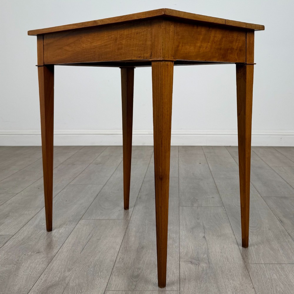 An antique early 20th-century walnut side table with a flat rectangular top, plain frieze, and four square tapered legs. View VI