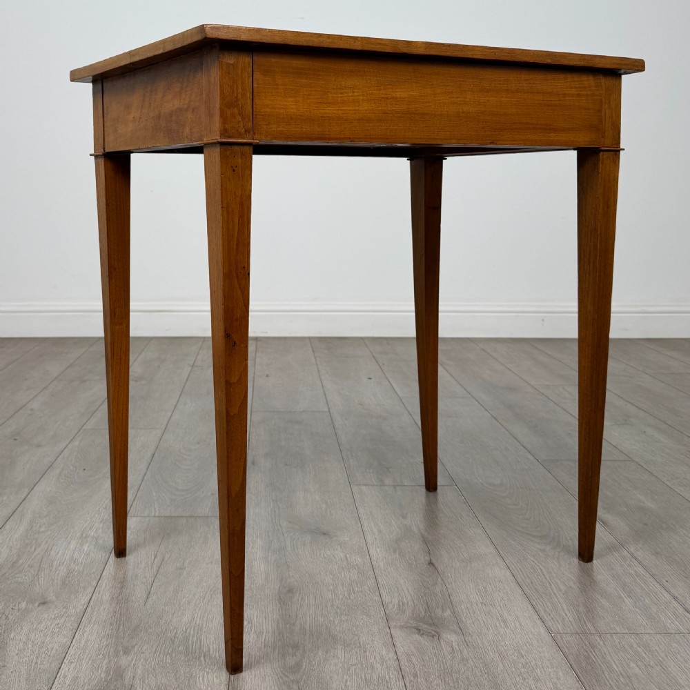 An antique early 20th-century walnut side table with a flat rectangular top, plain frieze, and four square tapered legs. View VIII