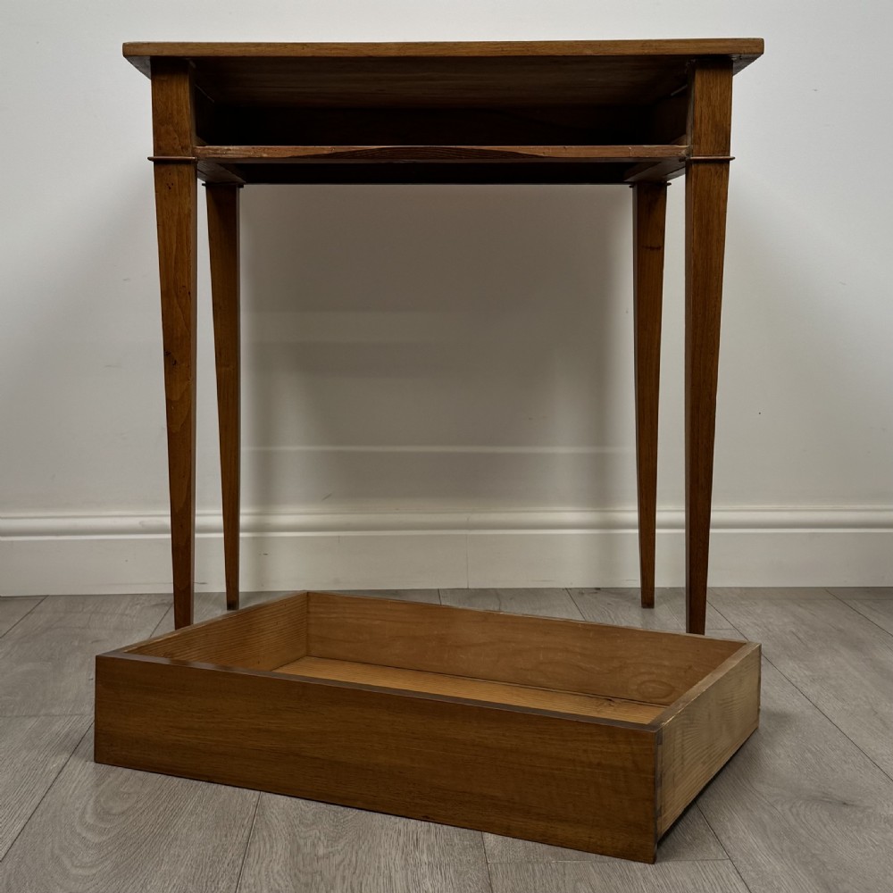 An antique early 20th-century walnut side table with a flat rectangular top, plain frieze, and four square tapered legs. View X