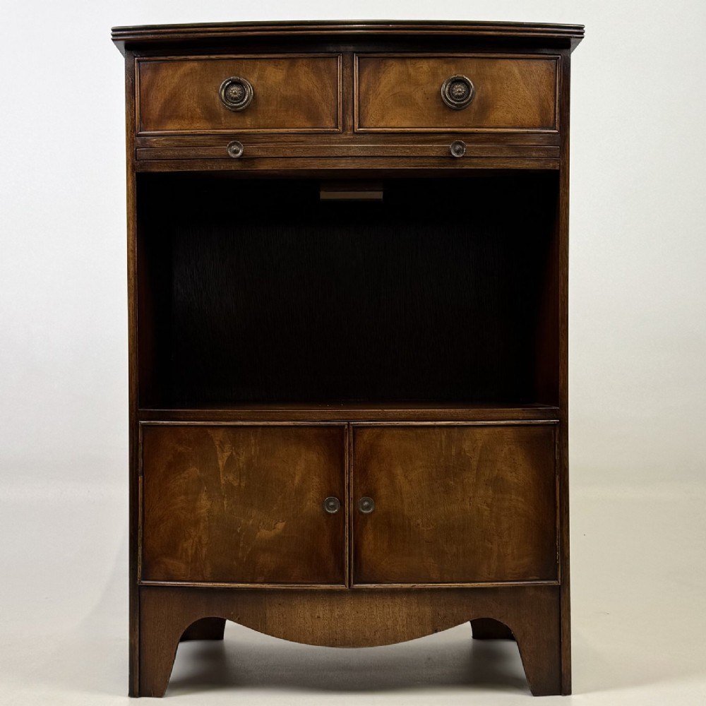 A dark mahogany storage cabinet featuring top drawers, an extendable pull-out slide, an open alcove shelf, and a lower double door cupboard.