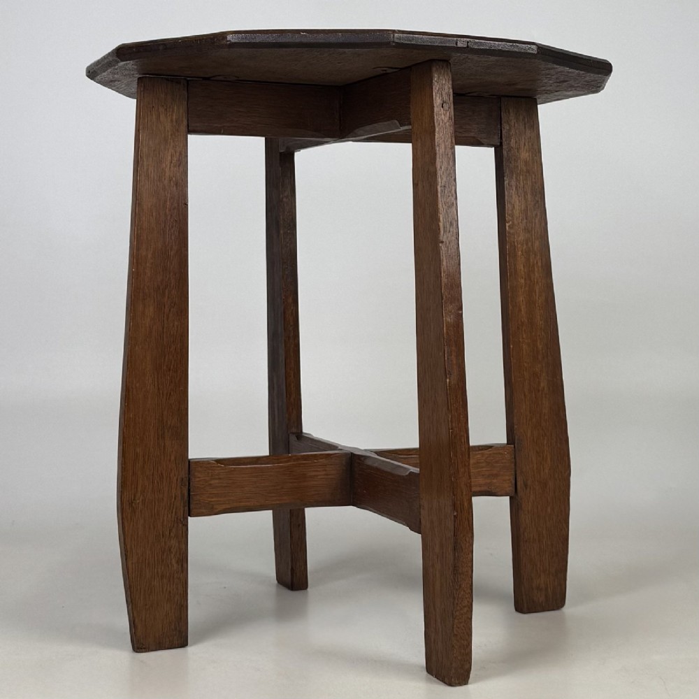 An antique Arts and Crafts solid oak lamp table featuring a twelve-sided polygonal top supported by four tapered square legs and cross-stretchers.