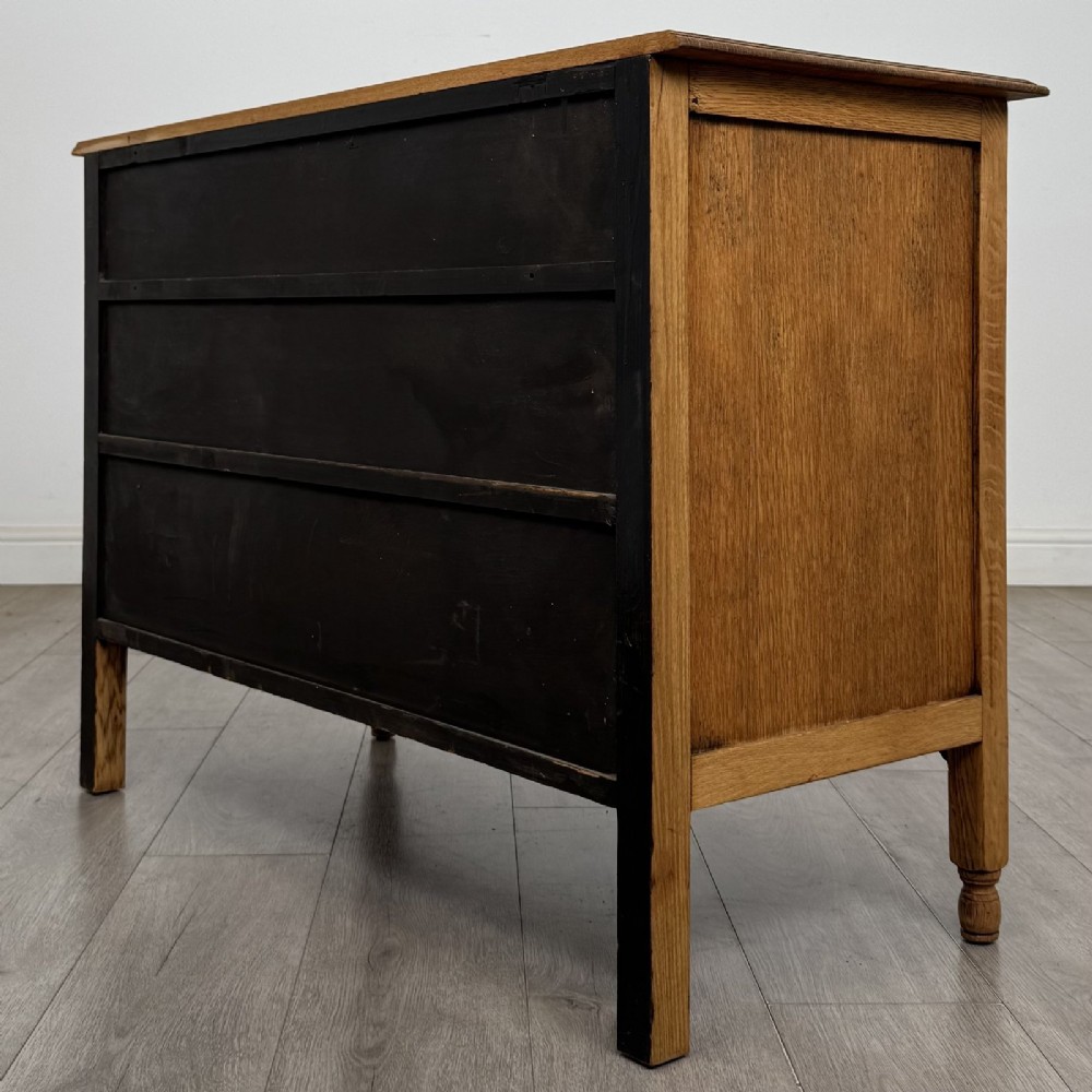 An Edwardian quarter-sawn oak chest of drawers with two short drawers over two long drawers and turned wooden handles. View VI