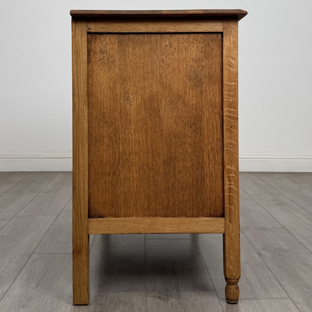 An Edwardian quarter-sawn oak chest of drawers with two short drawers over two long drawers and turned wooden handles. View VII