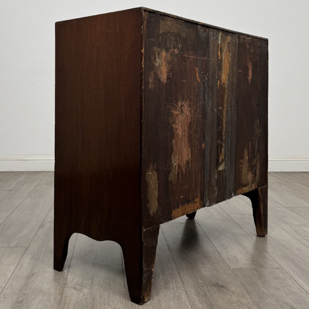 A 19th-century dark mahogany bow front chest of drawers featuring two short drawers above two long drawers with turned wooden handles and bracket feet. View IV