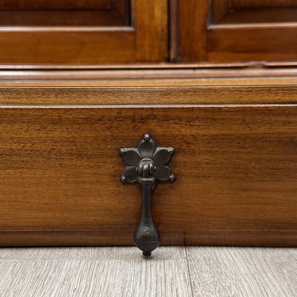 An antique Victorian mahogany glazed bookcase featuring two upper glass doors, twin frieze drawers, and lower panelled doors. View XIII