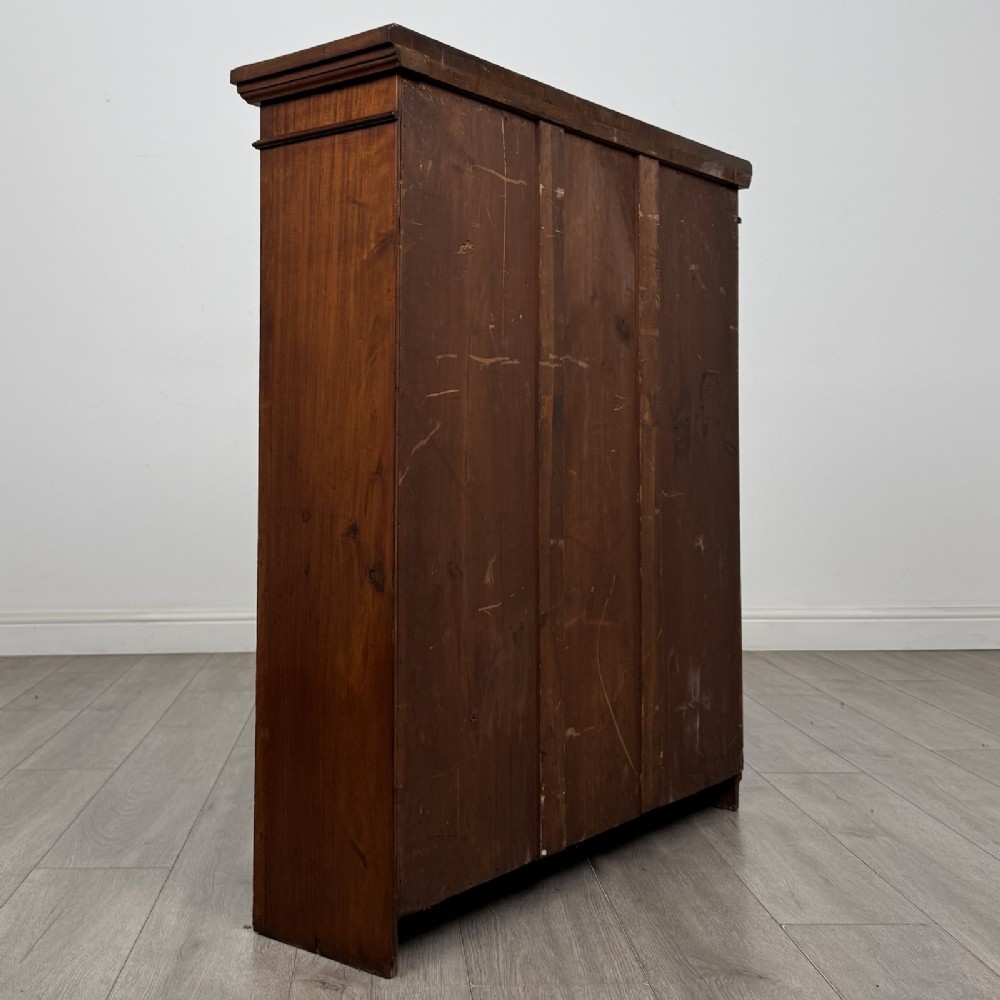 A dark brown Victorian pine open bookcase featuring adjustable shelving, reeded side pilasters, and a shaped apron at the base. View V