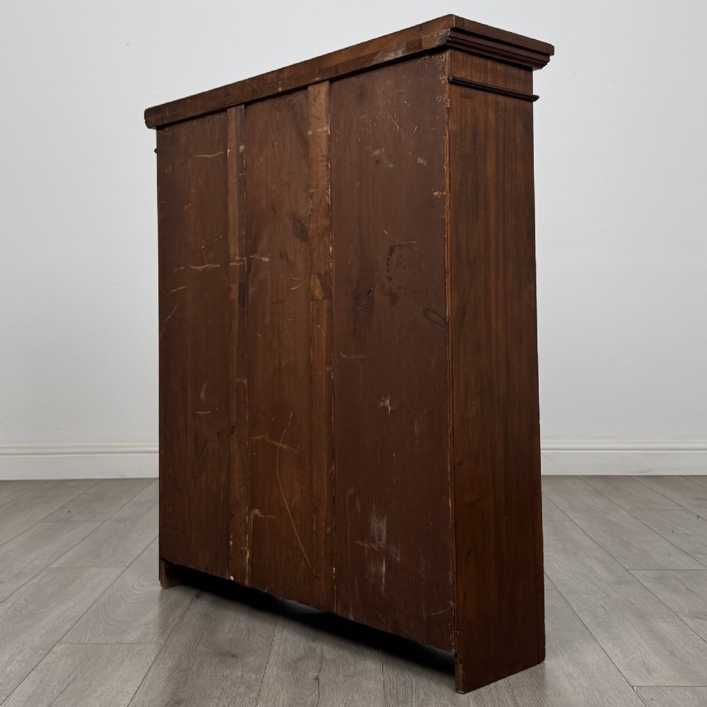 A dark brown Victorian pine open bookcase featuring adjustable shelving, reeded side pilasters, and a shaped apron at the base. View VII