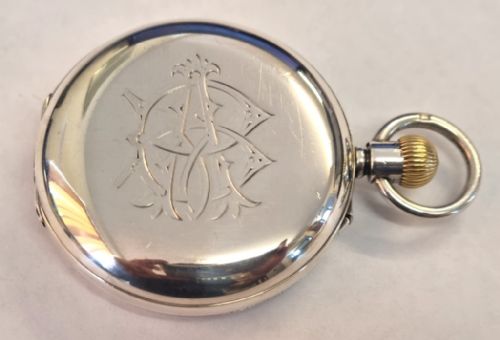 fig 1. An English Lancashire Watch Co silver full hunter pocket watch shown open, featuring a white enamel dial with black Roman numerals, blued steel hands, and a sub-seconds dial.