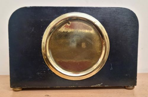fig 1. A rectangular black lacquered French mantel clock featuring gold chinoiserie decoration, a brass bezel, and a white dial displaying Arabic numerals.