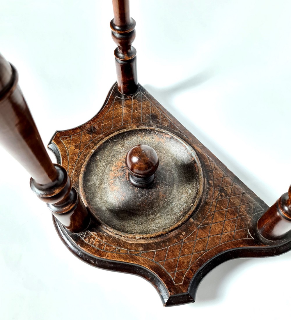 A 19th-century carved walnut stick stand featuring turned upright supports, finials, cross-hatched geometric carving, and a metal drip tray base. View IV