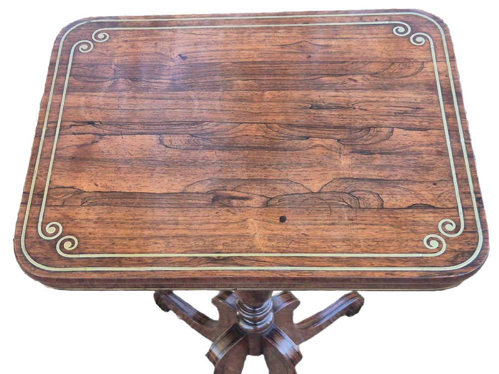 A Regency period rosewood occasional table featuring a brass inlaid rectangular top, a turned central pedestal, and three downswept tripod legs. View III