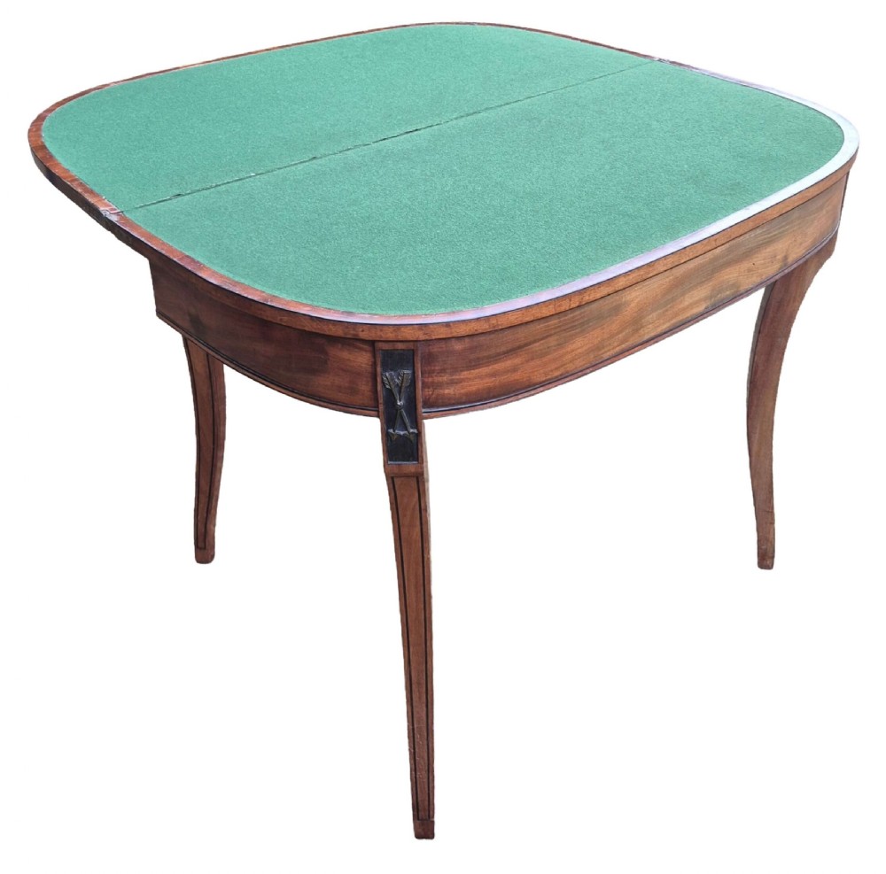 An antique George III mahogany demilune card table featuring slender shaped legs, inlaid stringing, and a fold-over top. View II