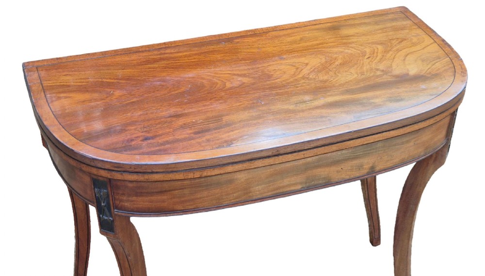 An antique George III mahogany demilune card table featuring slender shaped legs, inlaid stringing, and a fold-over top. View IV
