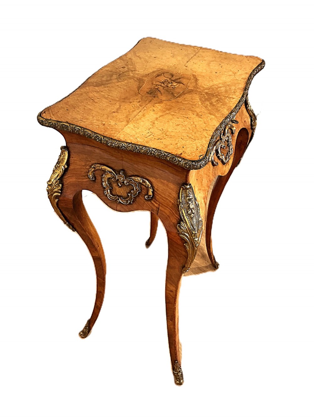 A 19th-century French walnut occasional table featuring cabriole legs, decorative gilt-bronze mounts, marquetry inlay on the top, and a moulded metal rim. View II