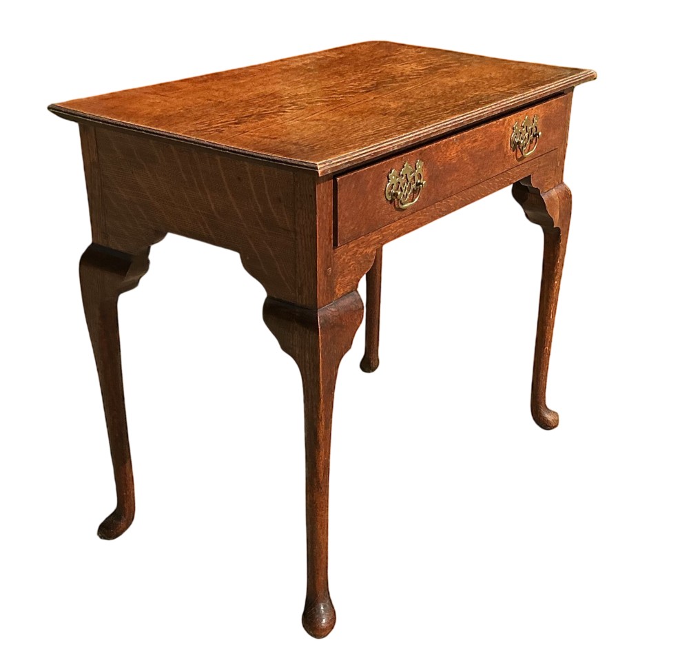 A George III rectangular oak side table featuring a single drawer with brass backplate handles and cabriole legs. View II