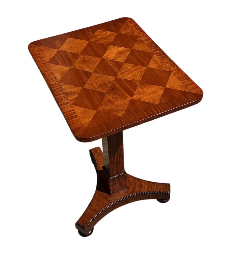 A Late Regency mahogany occasional table featuring a square parquetry top resting on a central column and a triform base. View II