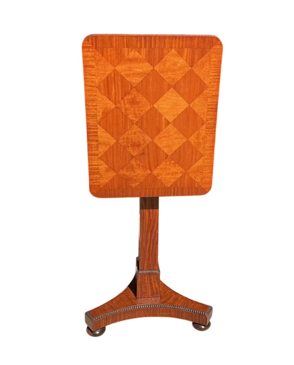 A Late Regency mahogany occasional table featuring a square parquetry top resting on a central column and a triform base. View III