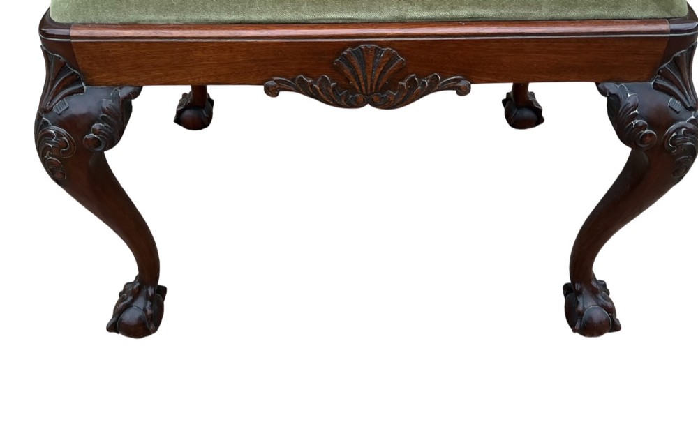 A Chippendale style mahogany stool featuring an olive green velvet upholstered seat, carved cabriole legs, and ball-and-claw feet. View II