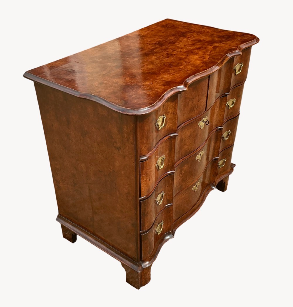 A mid-18th-century Dutch chest of drawers in warm brown burr walnut veneer with a shaped front and brass drop handles. View II
