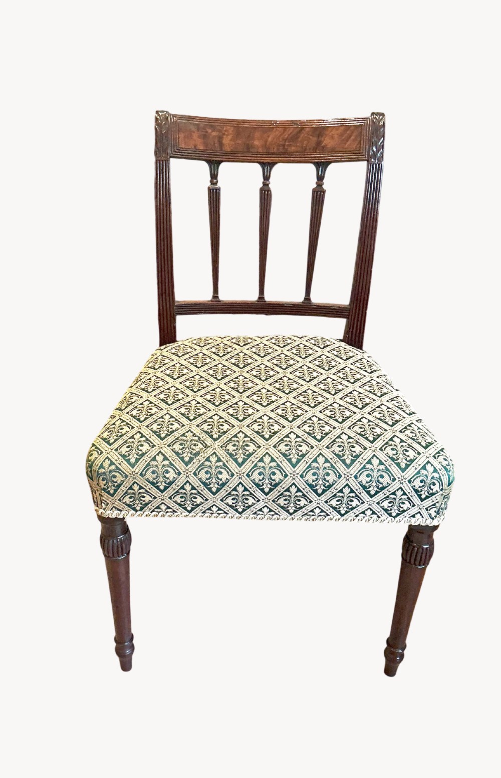 A set of six mahogany dining chairs featuring patterned fabric upholstered seats, vertical back splats, and reeded front legs. View II