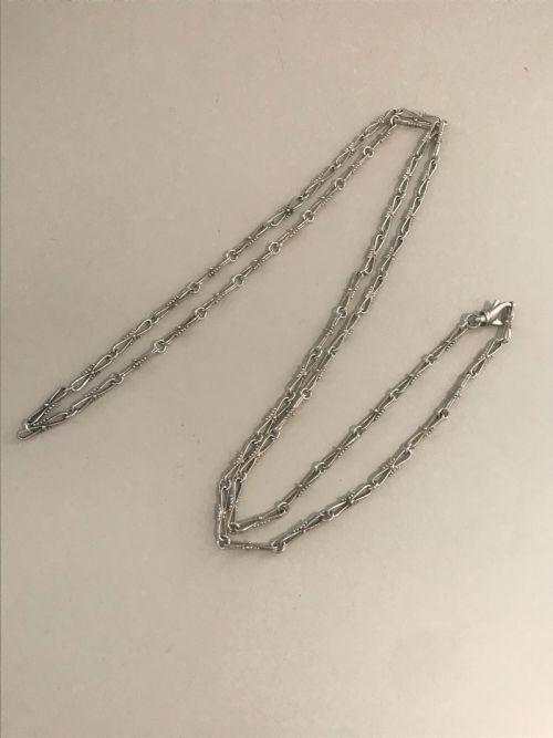 fig 1. A long vintage silver chain featuring decorative fancy links with subtle beaded wire details.