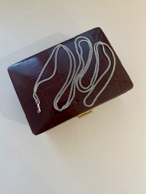 A very long Victorian silver guard chain