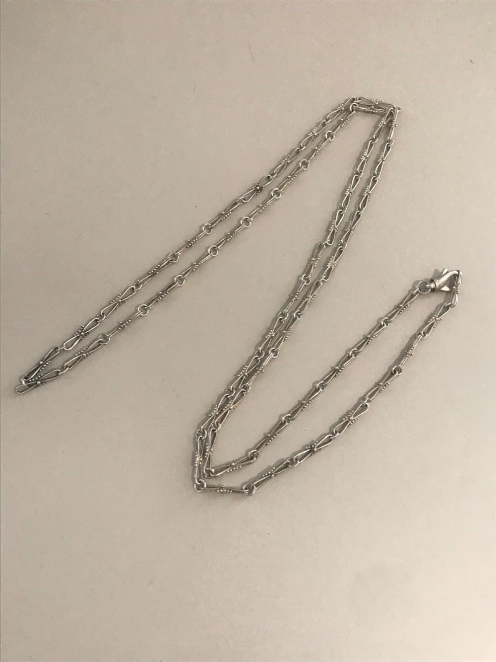 A long vintage silver chain featuring decorative fancy links with subtle beaded wire details. View II