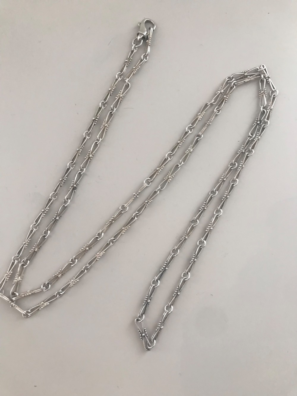 A long vintage silver chain featuring decorative fancy links with subtle beaded wire details. View VI