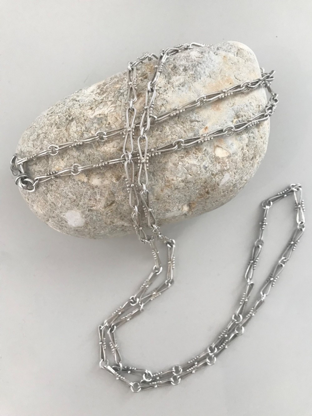 A long vintage silver chain featuring decorative fancy links with subtle beaded wire details. View VII
