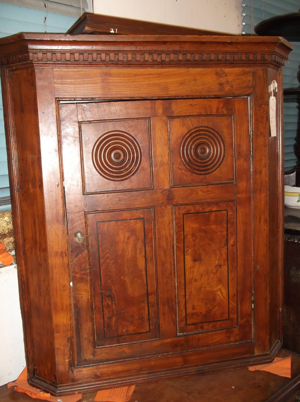 Early 19th century elm corner cupboard