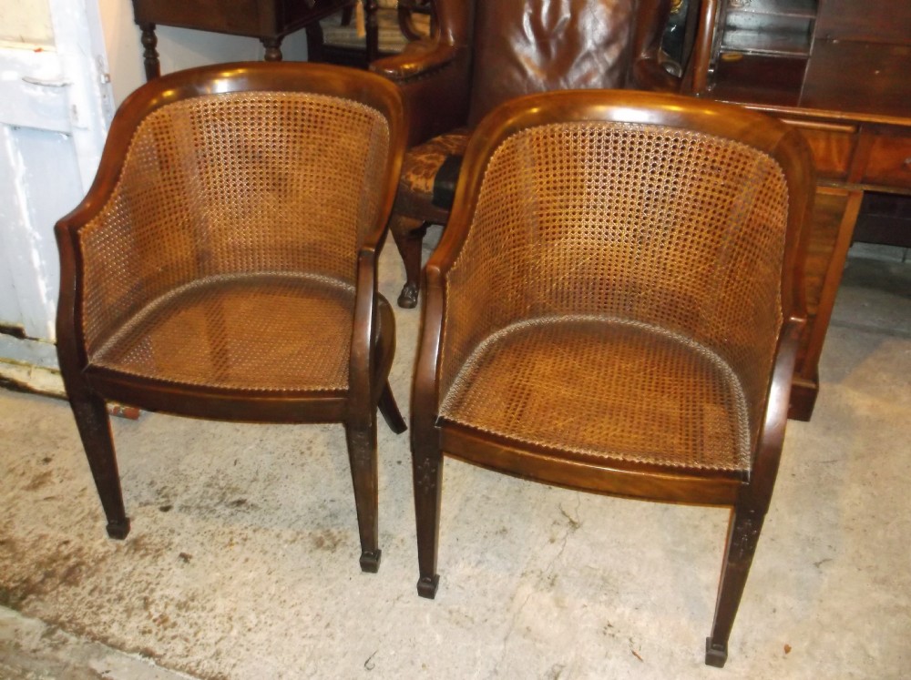 Pair of caned armchairs