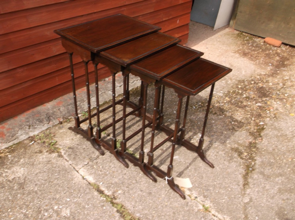 Nest of 4 mahogany tables.