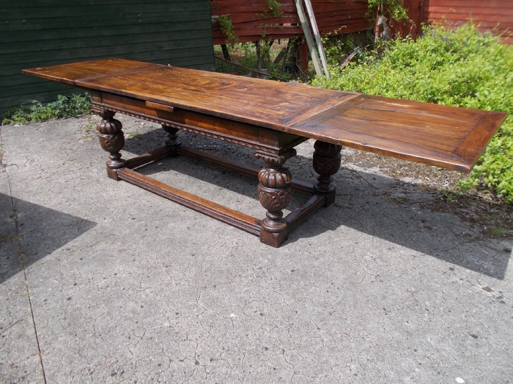 Large carved oak draw leaf dining table