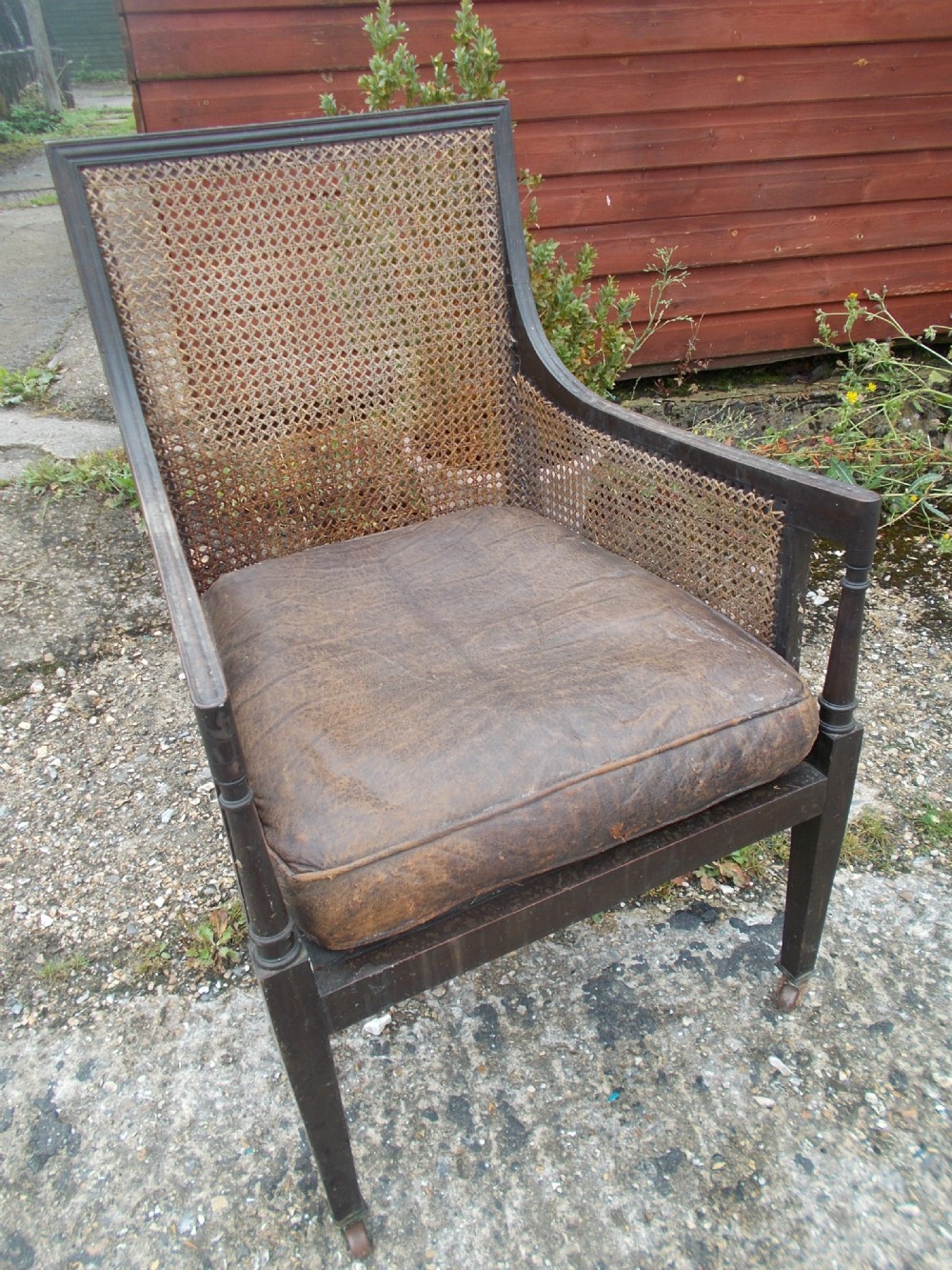 Mahogany bergere Library caned armchair
