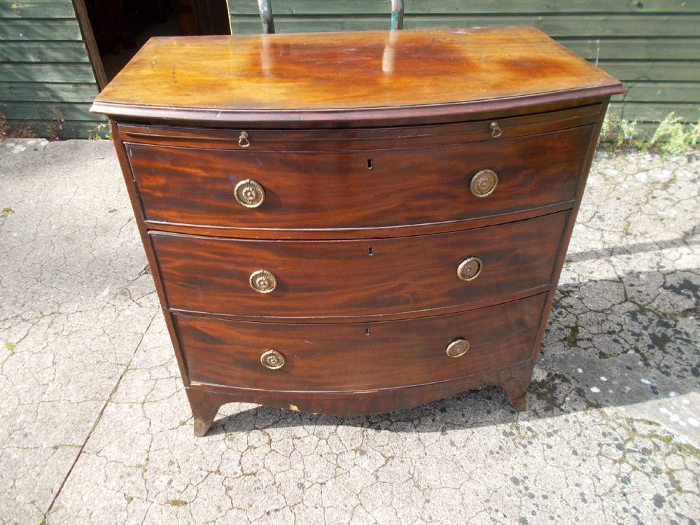 19th century mahogany bow front chest with slide.