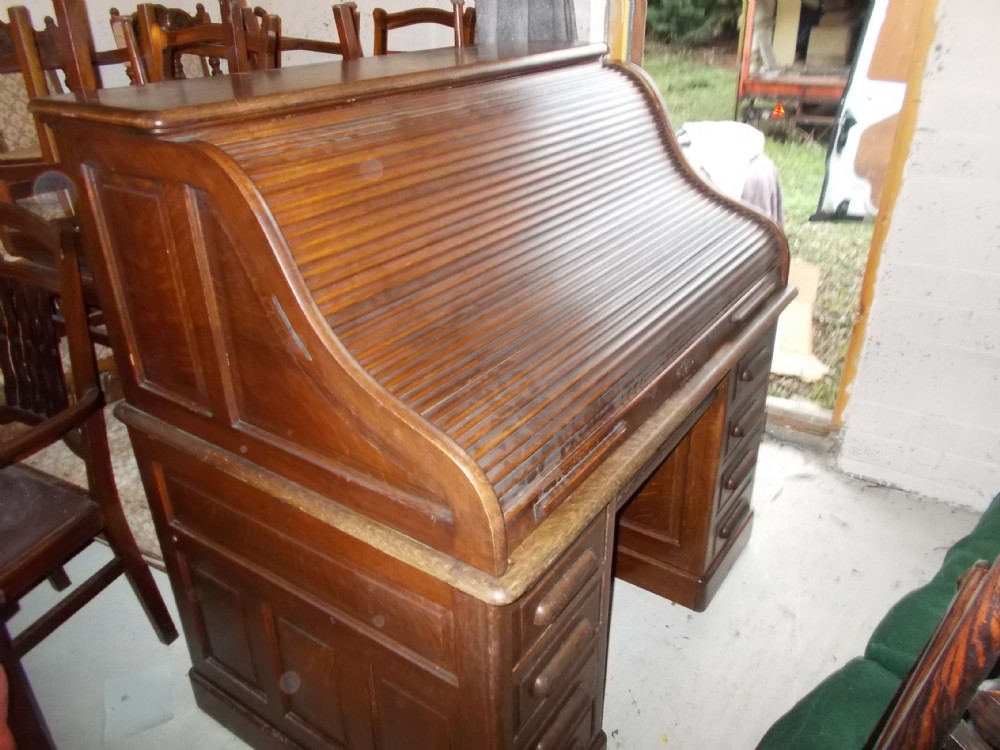 Early 20th century panelled oak roll top desk