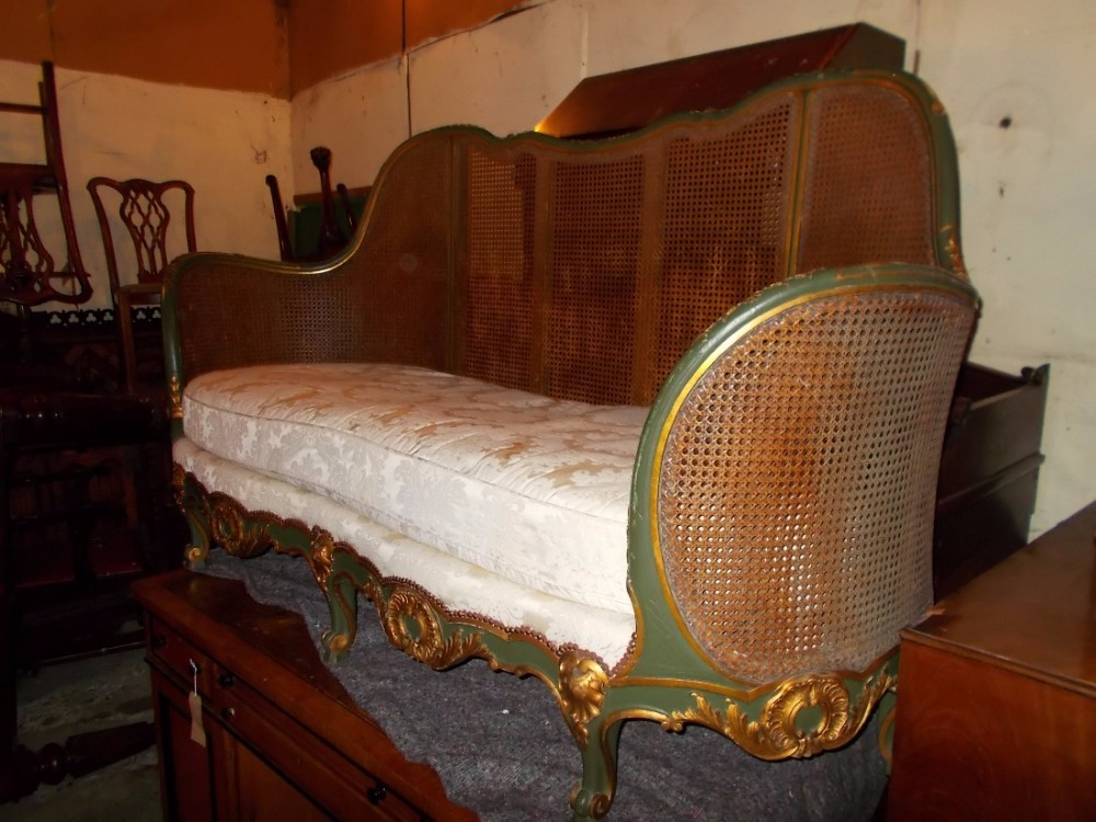 Early 20th century carved and decorated caned settee.