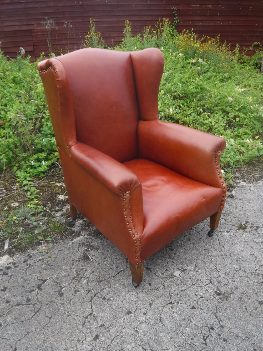 Early 20th century leather upholstered wing back armchair View II