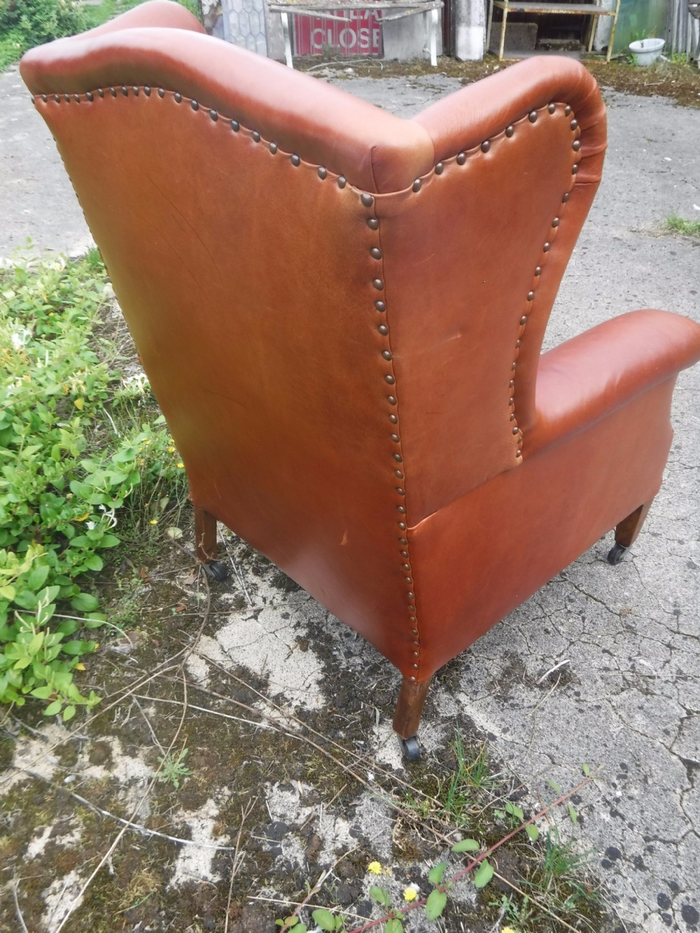 Early 20th century leather upholstered wing back armchair View IV