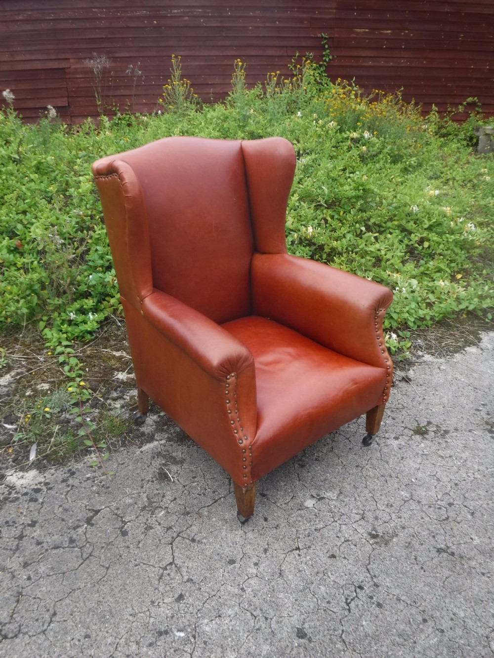 Early 20th century leather upholstered wing back armchair View V