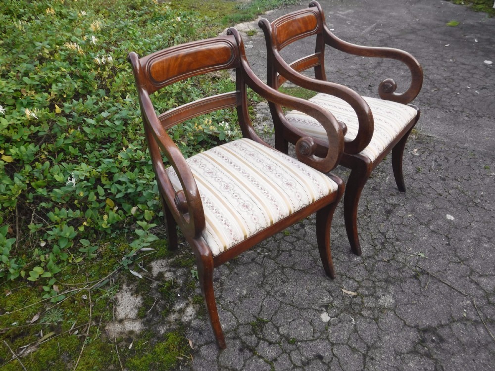Pair of 19th century mahogany sabre leg armchairs