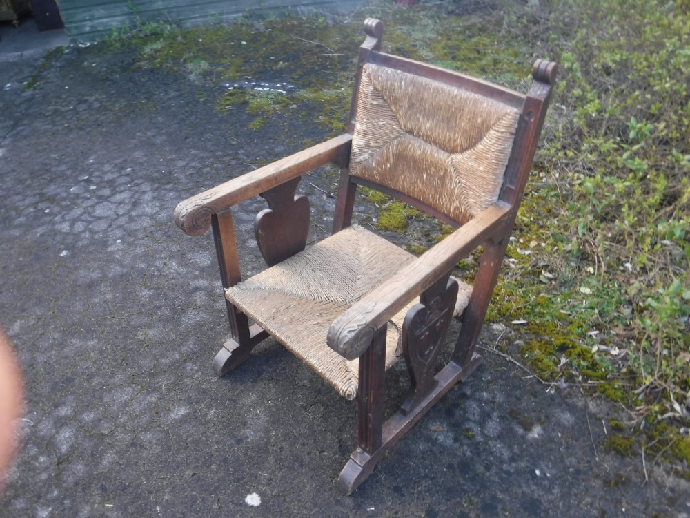 Unusual oak art and crafts rush seat armchair View IV