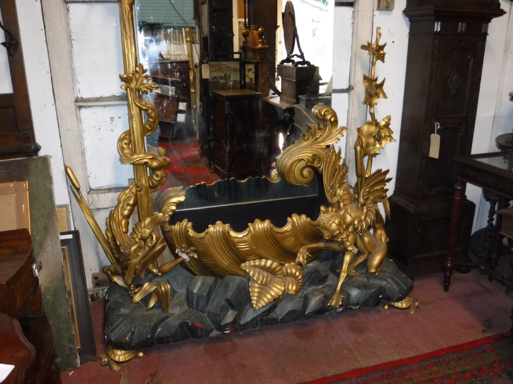 A tall giltwood hall mirror adorned with carved bamboo side pillars, mythical winged dragon motifs, and a carved shell base. View III