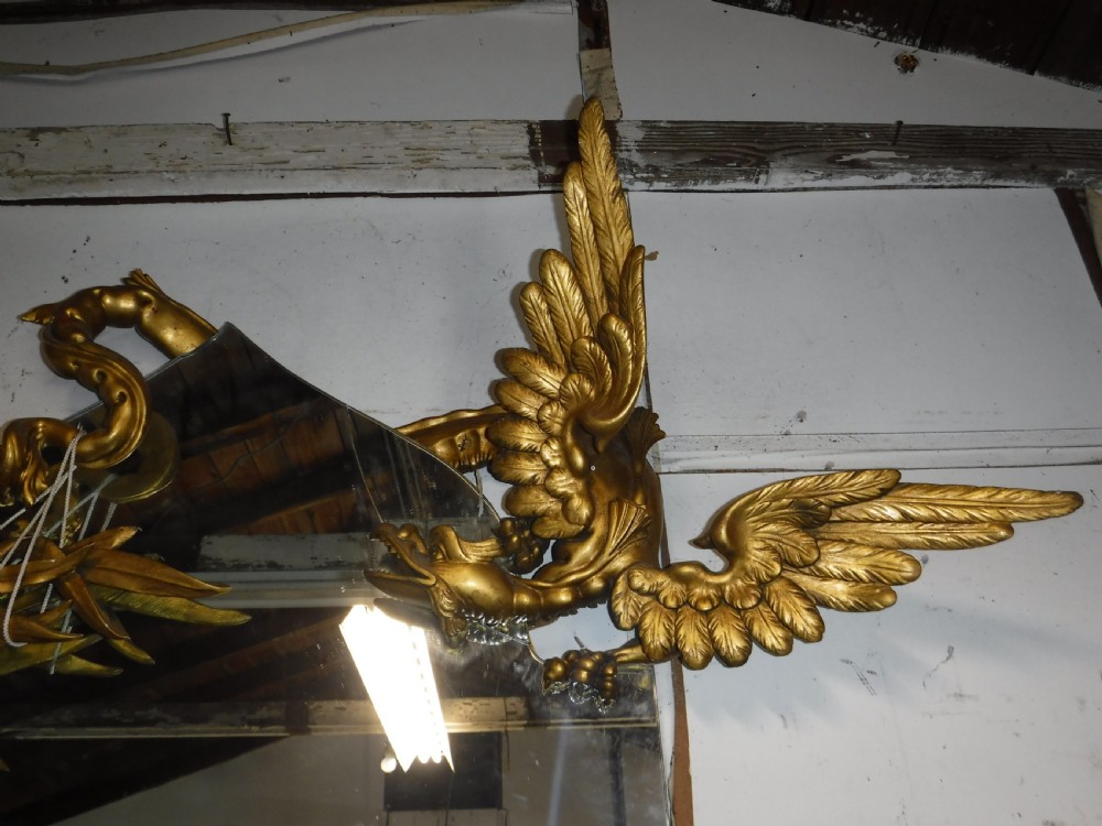 A tall giltwood hall mirror adorned with carved bamboo side pillars, mythical winged dragon motifs, and a carved shell base. View VI