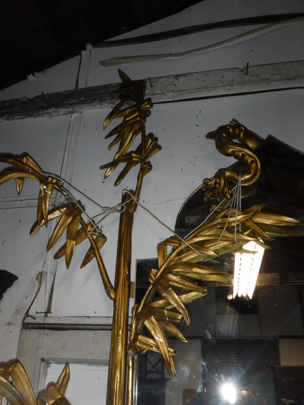 A tall giltwood hall mirror adorned with carved bamboo side pillars, mythical winged dragon motifs, and a carved shell base. View VII