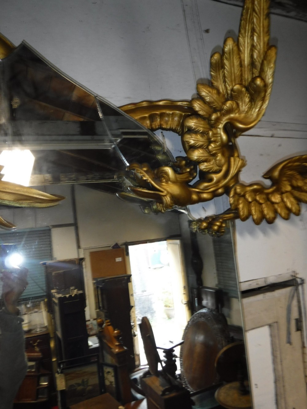 A tall giltwood hall mirror adorned with carved bamboo side pillars, mythical winged dragon motifs, and a carved shell base. View XV