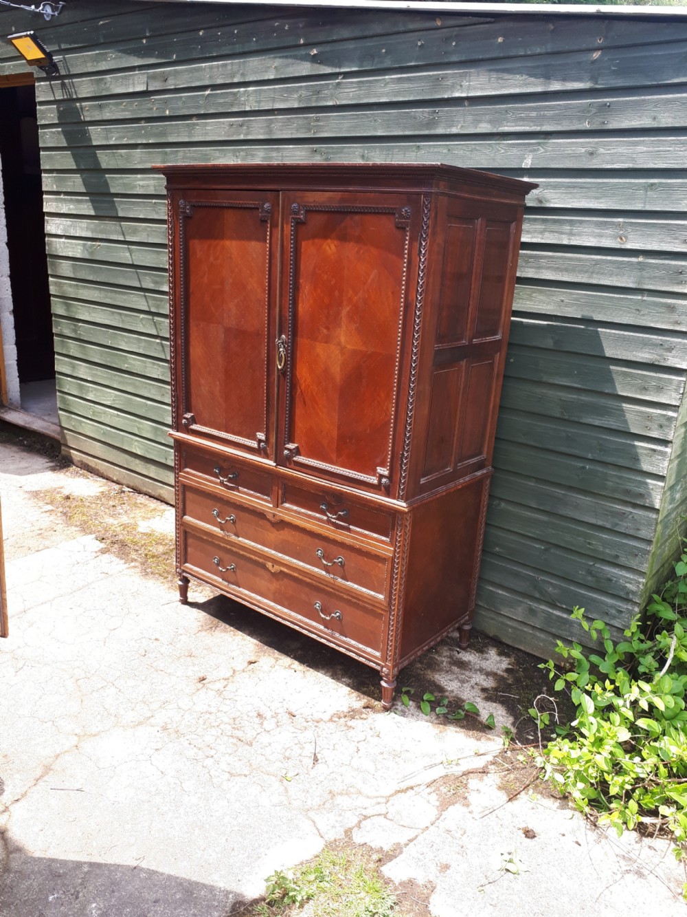 Dwarf panelled and carved linen cupboard