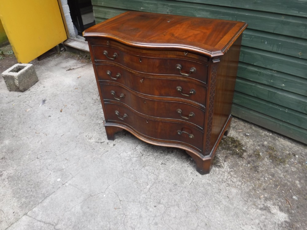Small early 20th century serpentine front mahogany chest View II